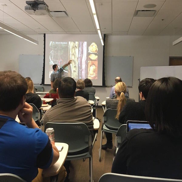 Professor Thomas Coats pointing at a slide during seminar series