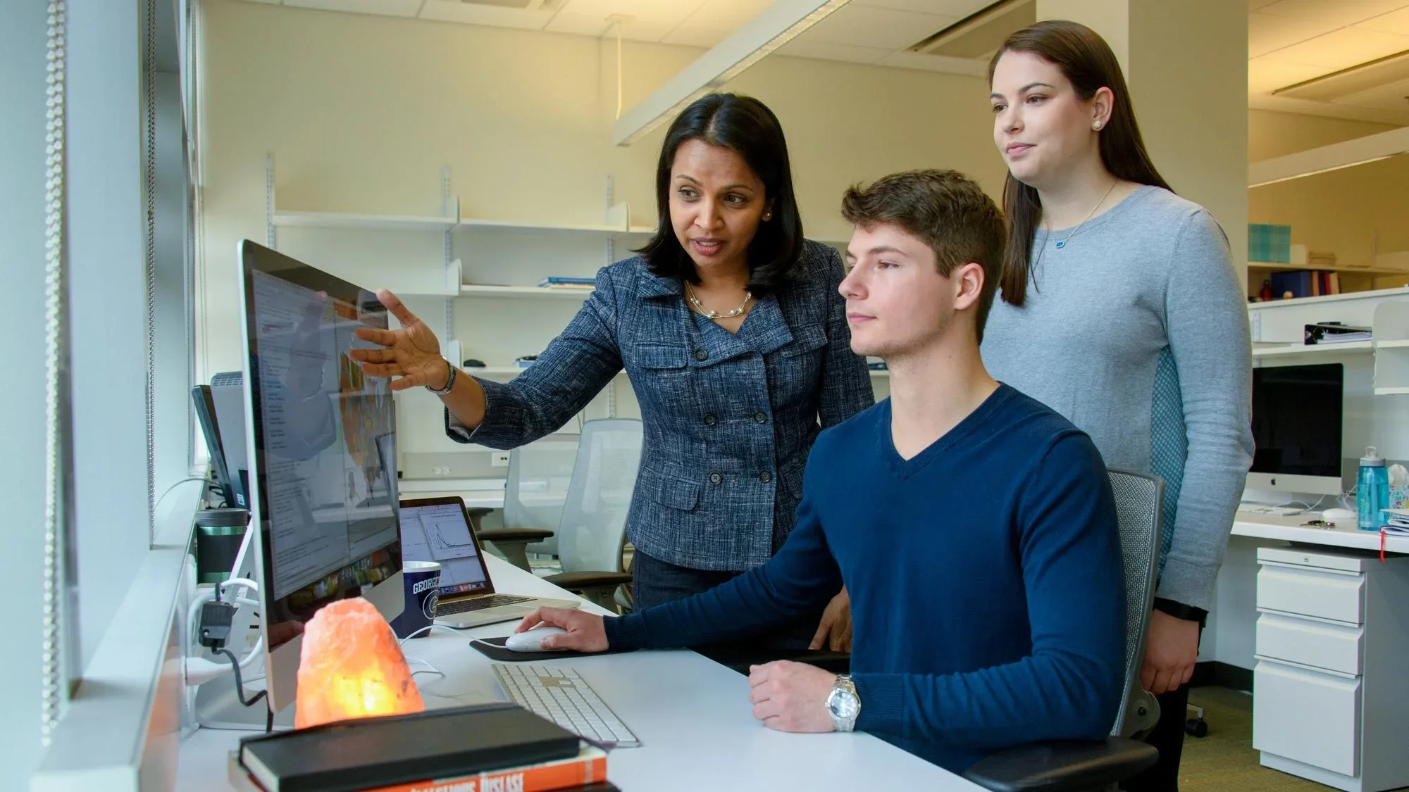 instrutor and student at a computer
