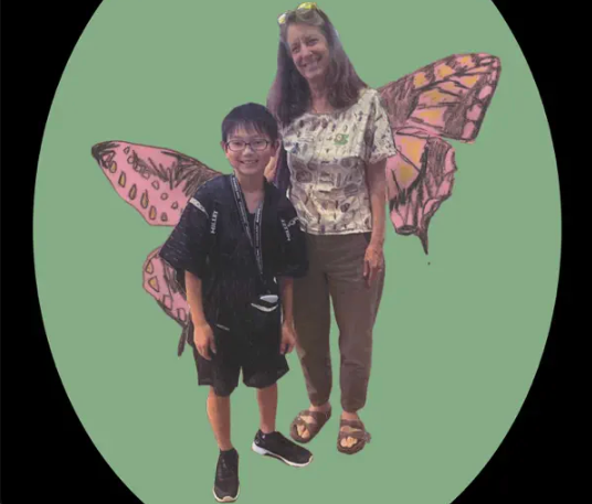 Image of faculty member, Dr. Martha Weiss,  with child—both have butterfly wings - from the Apple Podcast website